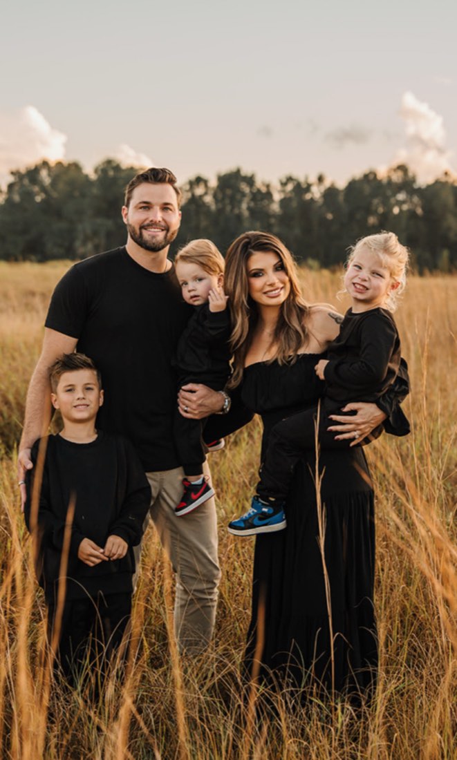 Justin and Stacey Messner with their three children at golden hour